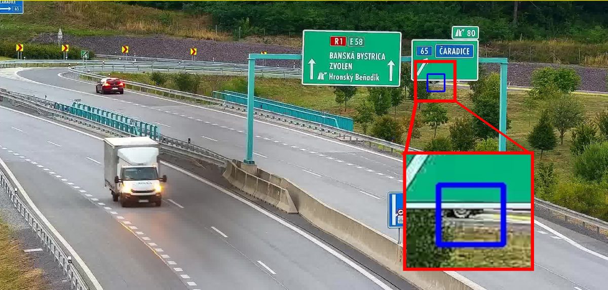 Stopped van almost completely hidden behind a direction sign, detected on a traffic camera