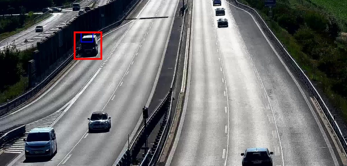 Stopped van on the edge of the expressway next to a noise barrier
