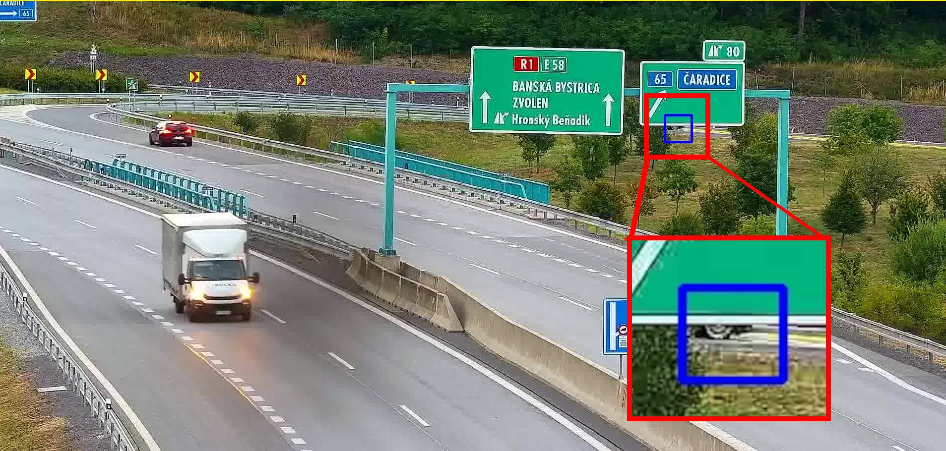 Stopped van almost completely hidden behind a direction sign, detected on a traffic camera