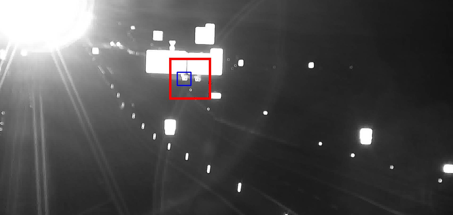 Stopped vehicle detected at night among static lights in the background